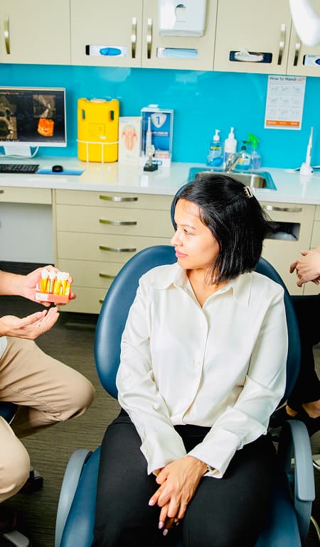 A dentist reviewing dental implant treatment information with a patient.