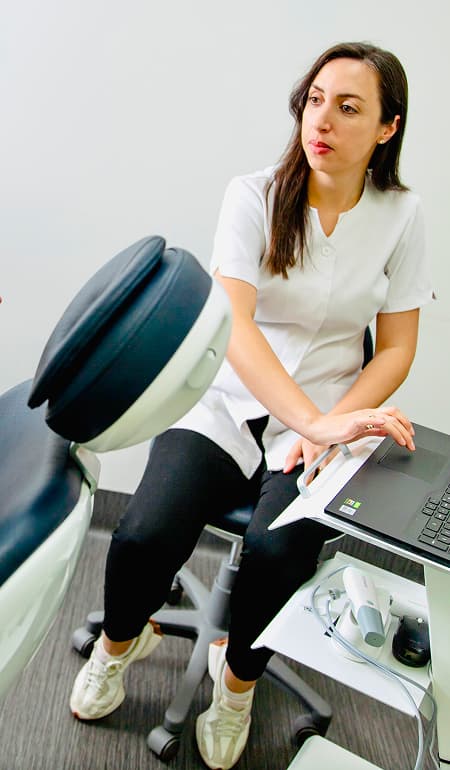 A dentist assessing a patient with an urgent dental concern.