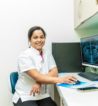 A Dapto dentist reviewing dental information at a computer.