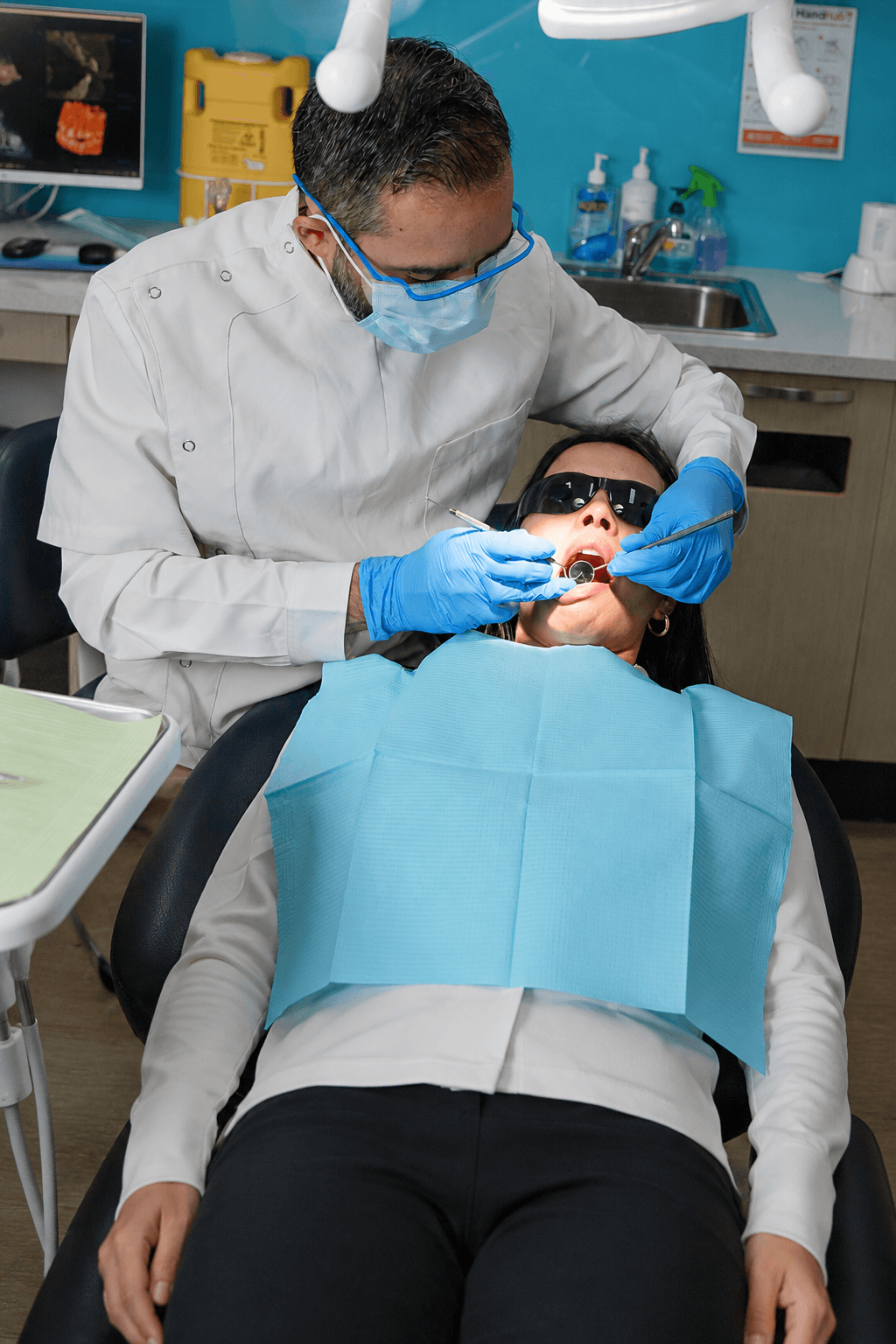 A dental professional speaking with a patient in a clinic.